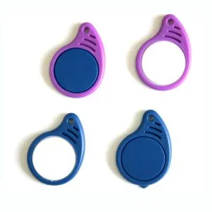 چار 125khz RFID Key Fobs جي تصوير, ٻه جامني ۽ ٻه نيري فوبس جي خاصيت. هر رنگ جي جوڙي ۾ هڪ اهم فوب شامل آهي هڪ مضبوط مرڪزي ڊسڪ سان ۽ هڪ کليل رنگ جي جوڙجڪ سان.