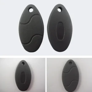 Two black, oval-shaped plastic key fobs with a small hole at one end. The top image displays both sides of the fobs together, while the bottom images feature each side individually. Ideal for use with an RFID Key Fob Duplicator (1).