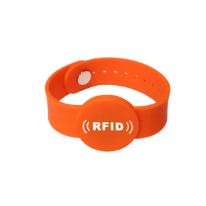 A vibrant orange RFID wristband featuring a circular central section showcasing "RFID" in white text, perfectly suited for RFID Wristband Solutions.